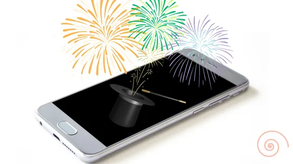 An image of a smartphone with a magicians hat on the screen and fireworks coming out of it.
