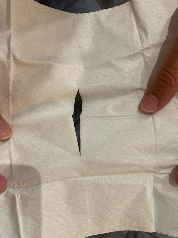 A picture of a tissue with a long narrow slit in it.